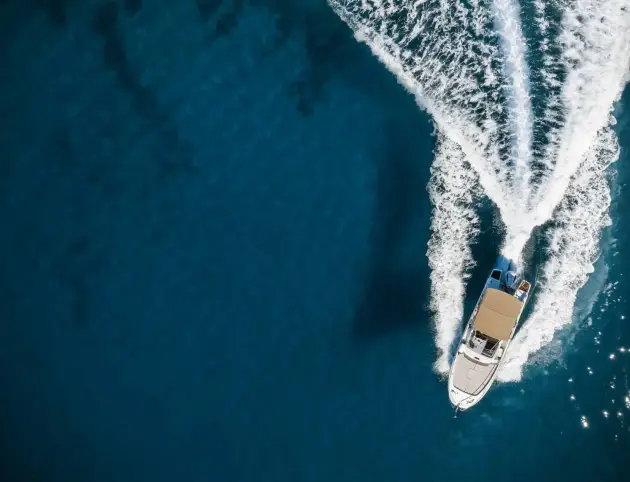 Speed boat in mediterrank_335513653-scaled-e1729809795909 Speed boat in mediterranean sea, aerial view